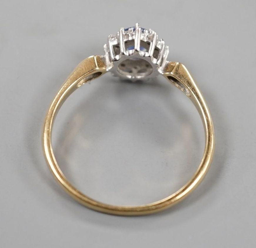 A modern 9ct gold, sapphire and diamond set cluster ring, size R, gross 2.3 grams.